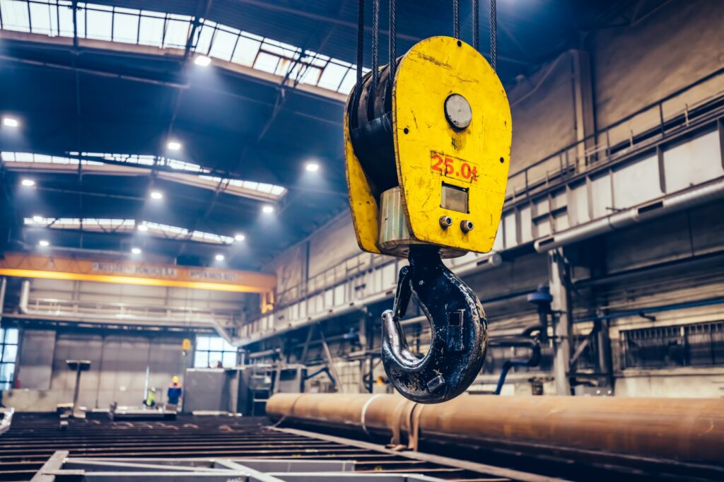 Crane hook in a big factory. Shipyard industry
